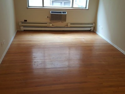 Polishing hardwood floors by Chicago Couch Cleaning.